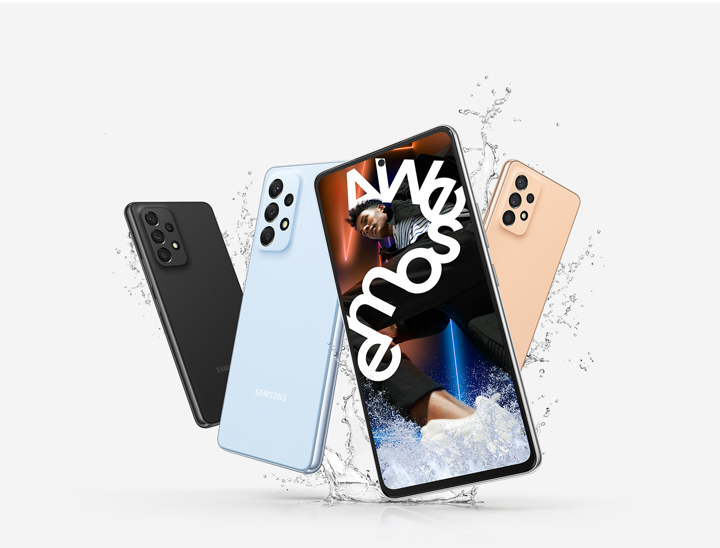 Four Galaxy A53 5G devices are shown with three of them showing the backside to display the Awesome Black, Awesome Blue and Awesome Peach colorways and a single front-facing Galaxy A53 5G shows a vivid picture of a man who is wrapped in white text reading Awesome.