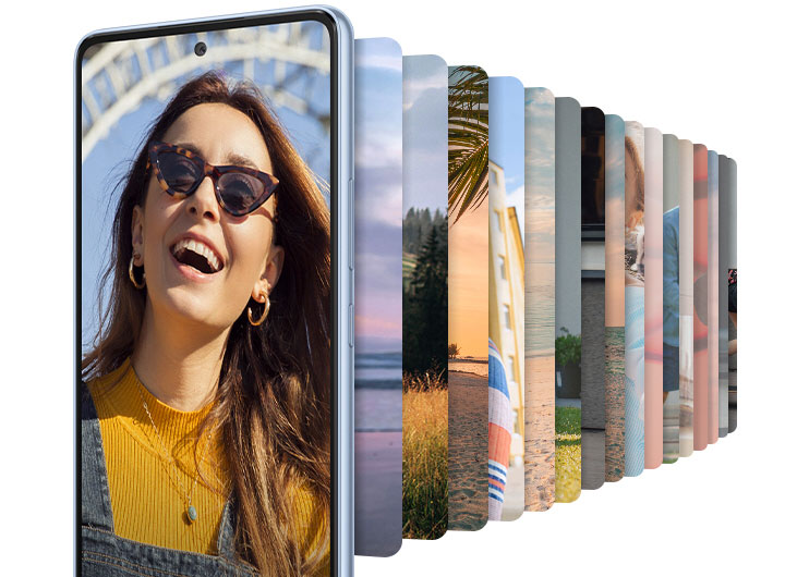 Galaxy A53 5G seen from the front, displaying an image of a woman in sunglasses, smiling. Behind the smartphone are numerous pictures in the smartphone shape, lined up and showing various landscape environments. Text reads RAM 6G/8GB +Extra virtual RAM and Storage 128/256GB +Up to 1TB (Micro SD card).