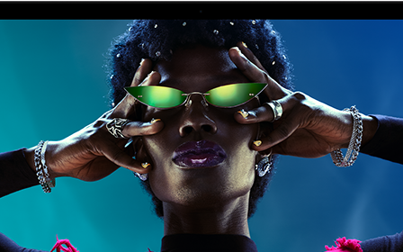 Colorful screen on a MacBook Pro of a person crowd-surfing at a party, showcasing the vibrant Liquid Retina XDR display