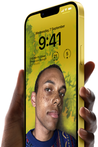 A hand holding an iPhone 14 Plus in yellow displaying a personalized Lock Screen.