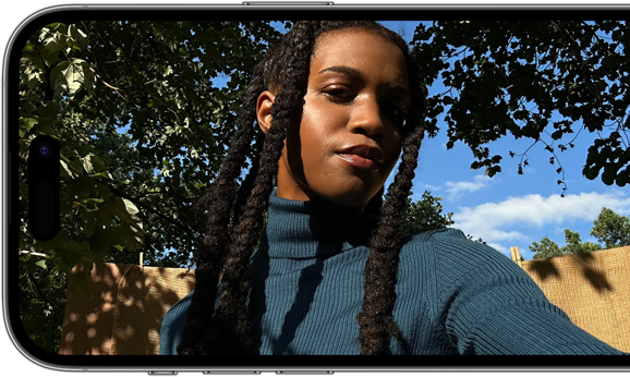 A horizontal view of an iPhone 14 Pro displaying a sharp and vibrant selfie.